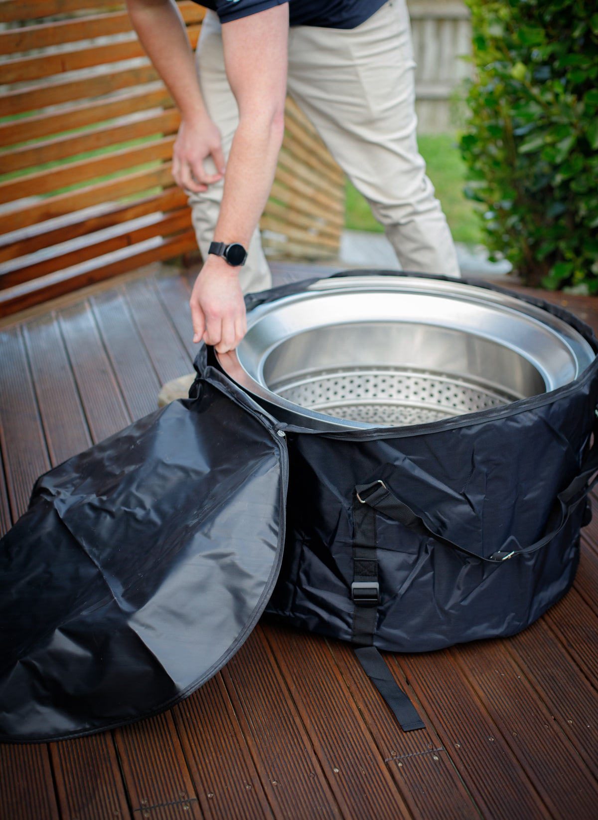 Person opening the fire pit carry bag